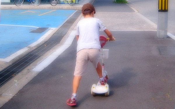 キックボードで遊ぶ子供の写真